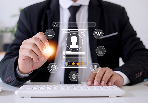 Person reviewing a digital resume interface with candidate rating icons on a computer.